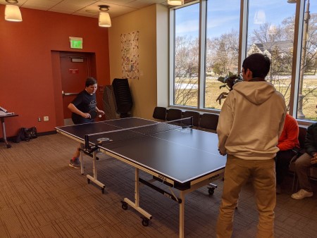 Teens playing ping pong